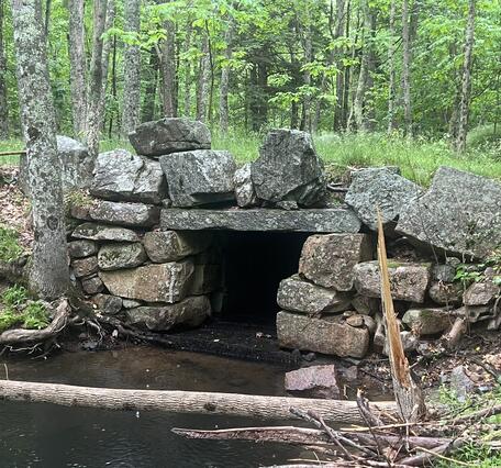 A culvert made with large boulders in a small stream.