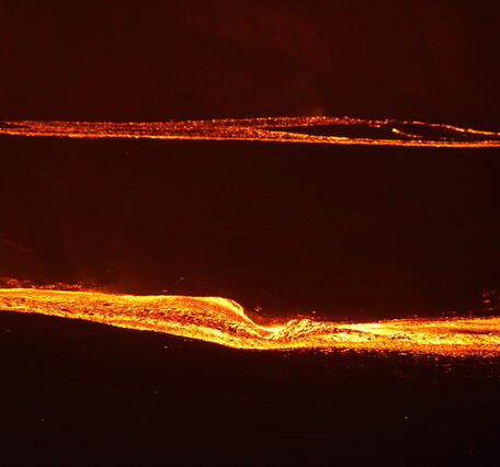 Color telephotograph of lava streams at night