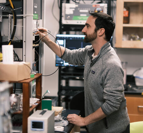 Person in lab working with equipment
