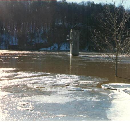 Looking out over the flooded Delaware river at the gage house standing alone in the waters