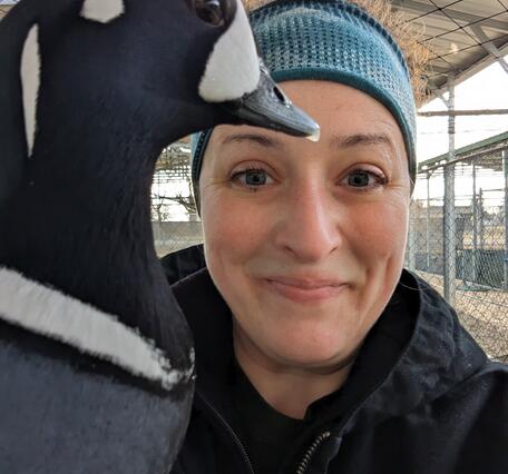 young woman wearing a headband holding a duck.