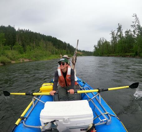 Girl paddling on raft on water