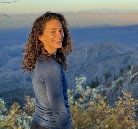 A picture of Ellie Broadman with mountains in the background
