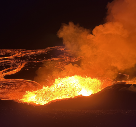 Color photograph of lava fountain at night