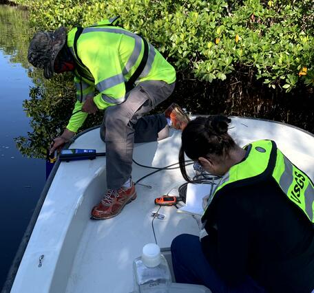 Two scientists sampling water in the Shark River Slough in Everglades National Park, Florida