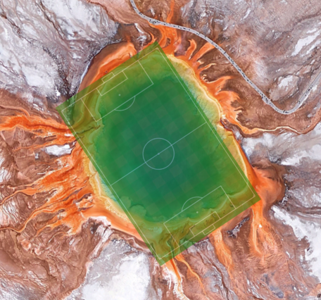 Aerial view of colorful Grand Prismatic Spring with a soccer field overlain and covering the spring's area almost exactly