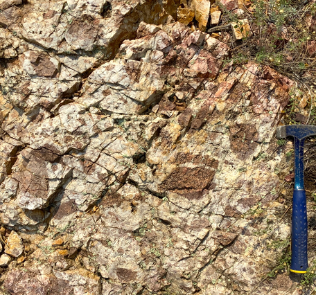 rock outcrop with hammer