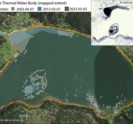Green lake surrounded by forest, with satellite inset of the same lake in winter with a few ice-free areas on the lake