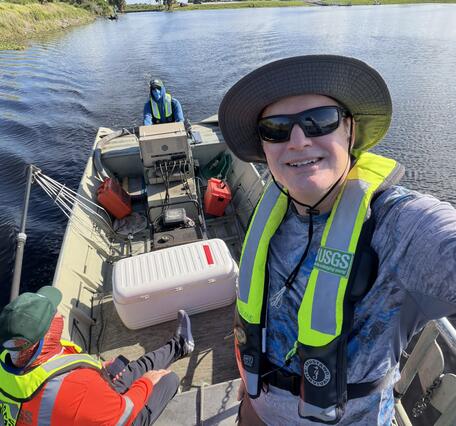USGS crew stand and sit in a boat during the May 2026 Fish Slam
