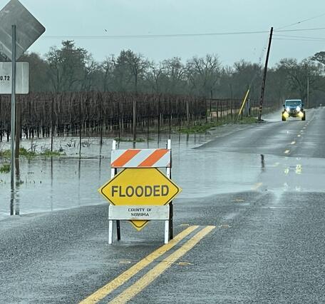 Flooded sign on a rainy road