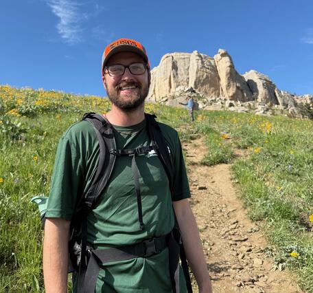 person standing in front of rock formation