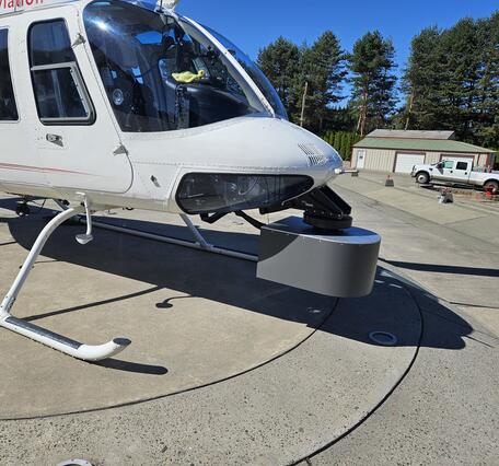 Bell Jet Helicopter with a thermal infrared and true-color sensor co-mounted to the underside