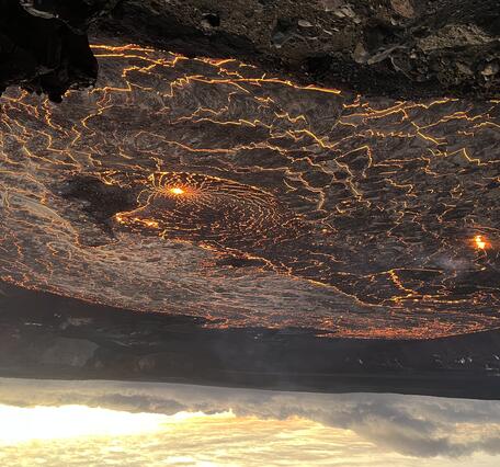 Color photograph of molten lava lake glowing