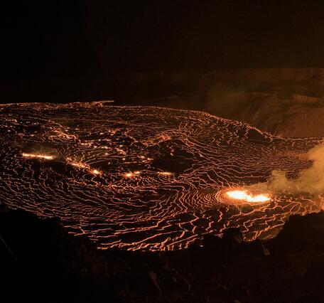 Color photograph of lava eruptive and feeding lava flows on crater floor