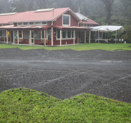 Color photograph of parking lot with volcanic deposits
