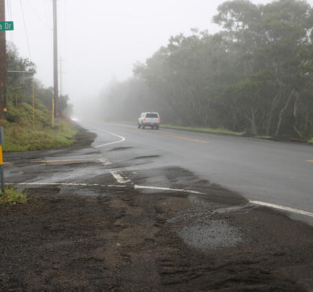  Color photograph of highway with volcanic fallout material cleared