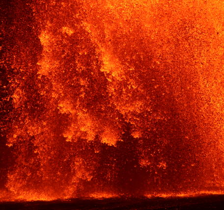 Color photograph of lava fountain at night