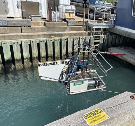Equipment being lowered into the water off a dock