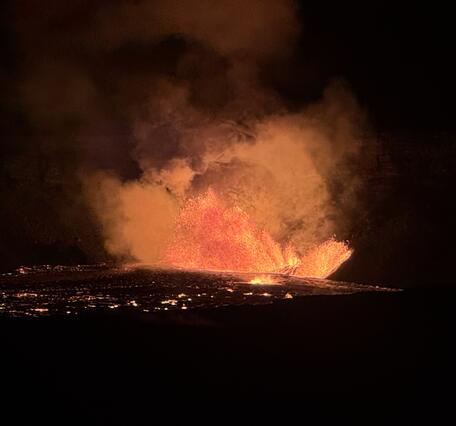 Color photograph of vents erupting lava