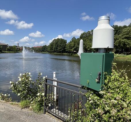 USGS hydrologic monitoring station along an urban waterfront walking path.