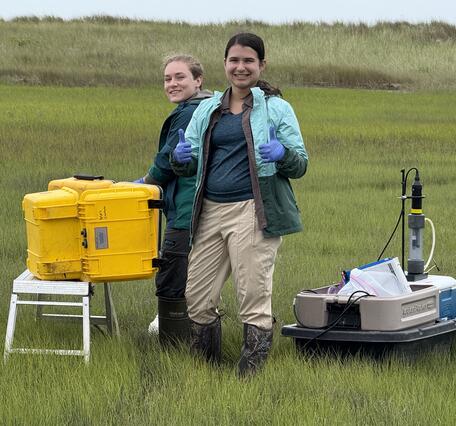 Two interns doing fieldwork in a coastal wetland