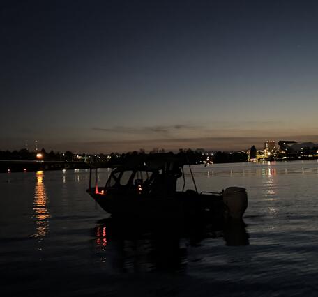 fieldwork boat on the water at dusk