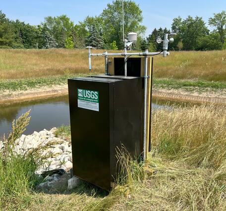 Constructed stormwater wetland upland native vegetation surrounding a USGS self-contained, solar-powered, monitoring station 