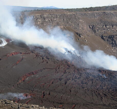 Color photograph of volcanic deposits around eruptive vents in Halemaʻumaʻu