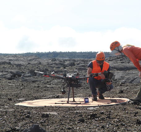Color photograph of two scientists inspecting UAS