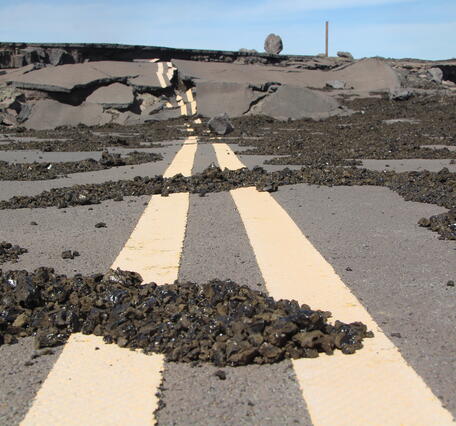 Color photograph of tephra on road