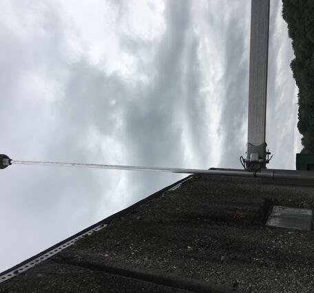 Looking up at the weather sensor attached to the side of the gage house