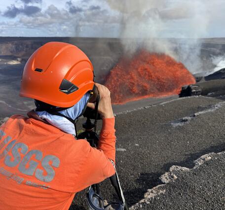 Color photograph of scientist monitoring eruption