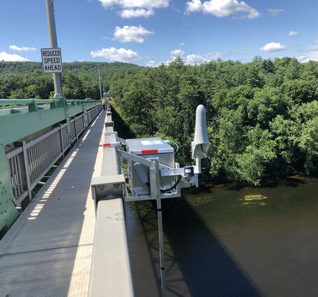 Looking across a high bridge at the radar telemetry box on the downstream side