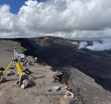 Color photograph of webcam on rim of volcanic crater
