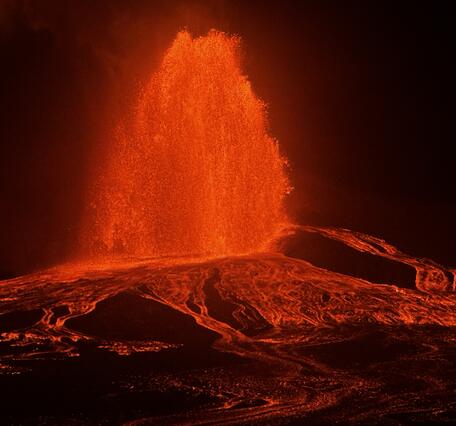 Color photograph of lava fountain at night