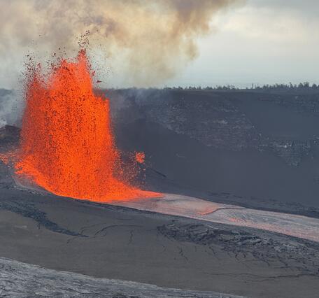 Color photograph of lava fountain and lava channel