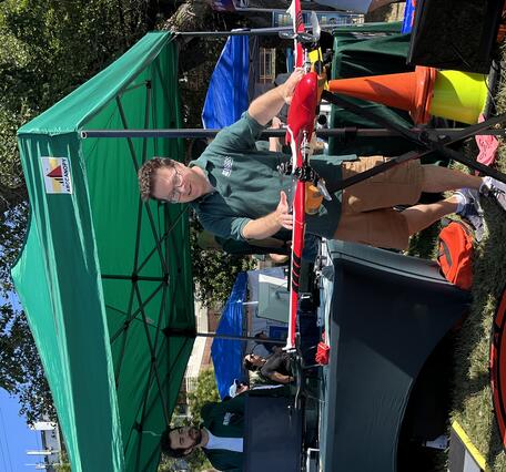 person showing drone to another person outside