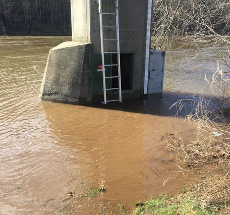 Looking at the Montague gage structure with flood waters up to the lower cleanout door