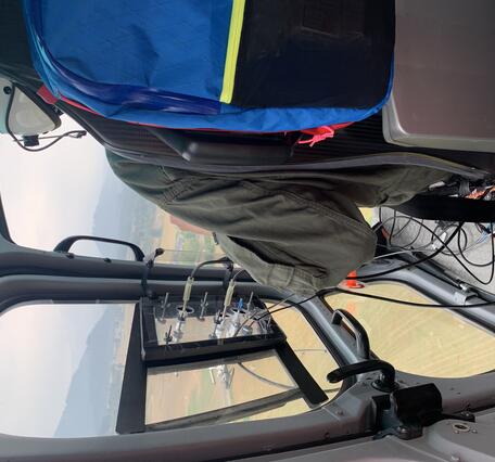 Color photo of the gas equipment looking out from the inside of the helicopter. 
