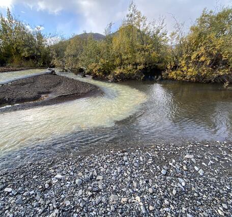 A pale orange and clear blue river mixing.