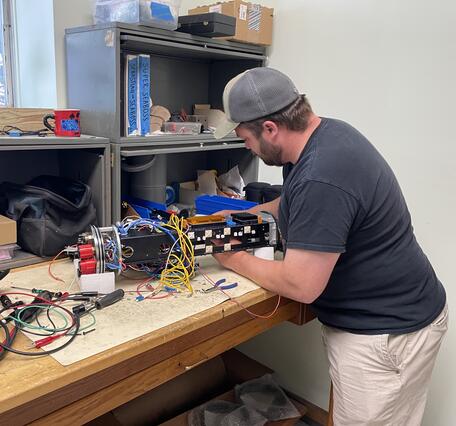 Person working on small piece of equipment