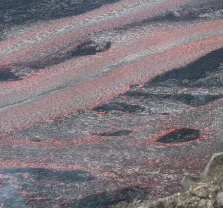 Color photograph of lava channels flowing during eruption