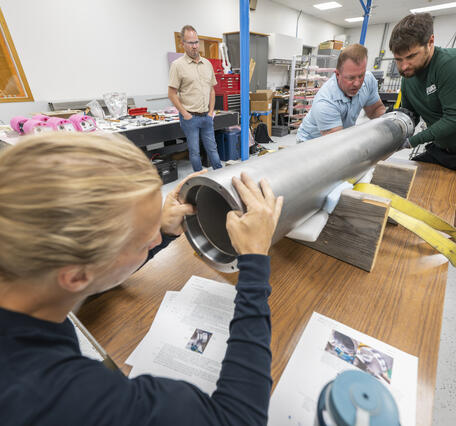 A group assembling a seismometer at the Physical Sciences Laboratory.