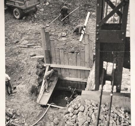 Wooden framework forming the hole into the ground at the foot of the old bridge