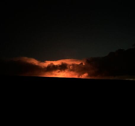 Color photograph of glow from volcanic eruption