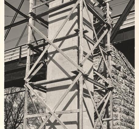 concrete structure is framed out at its full height next to a bridge