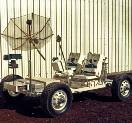 A photo of Grover the Geologic Rover against an aluminum corrugated wall
