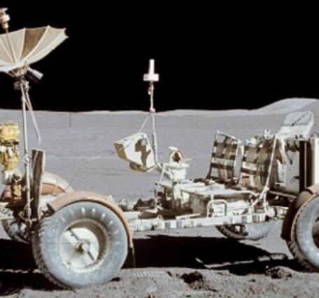 The lunar roving vehicle on the Moon: a bare-bones open cart-type vehicle with several instruments resting on the gray Moon
