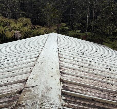 Color photograph of a roof with volcanic particles on it