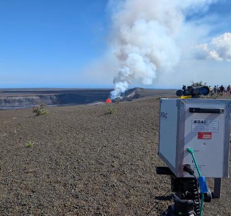 Volcano monitoring instrument pointed at a small lava fountain in crater